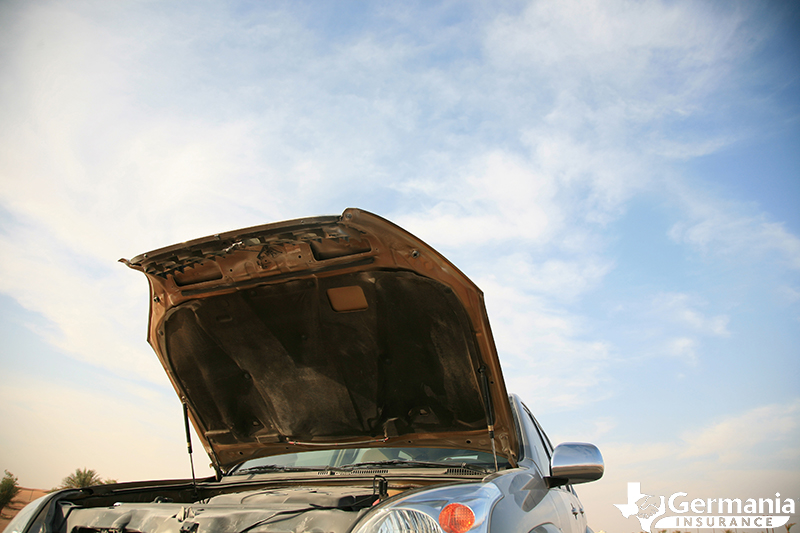 A car with an open hood exposing the engine