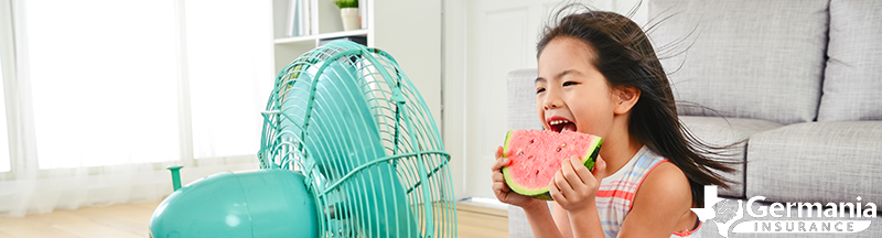 Young girl sitting in front of a fan, saving energy during the Texas summer