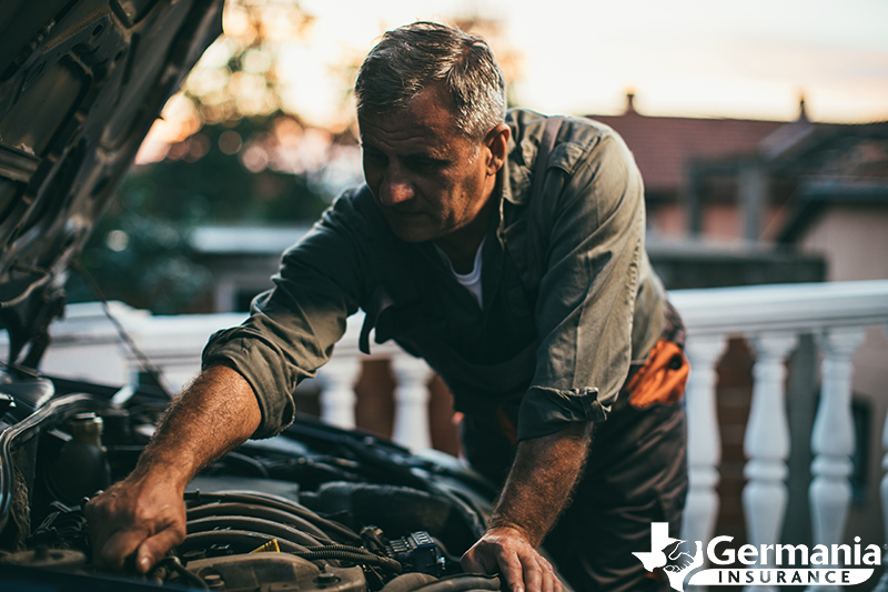 A man maintaining a vehicle he doesn't drive often