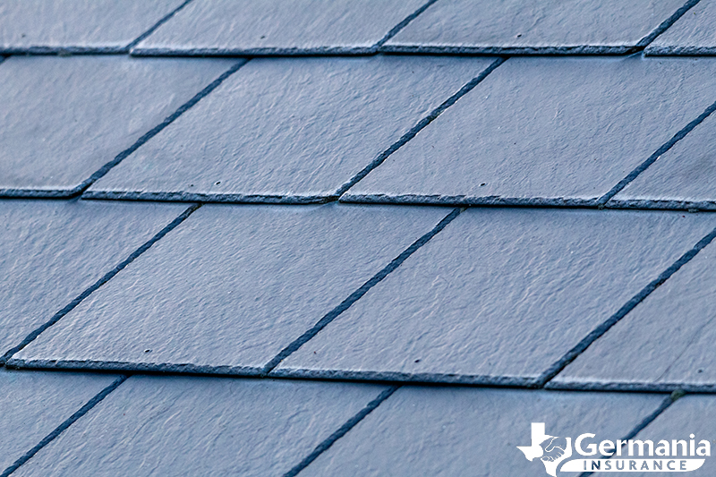 Slate shingles on a roof, demonstrating the different types of roof shingles.