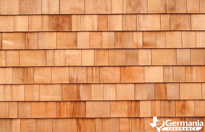A roof with wooden shingles showing the different types of roof shingles.