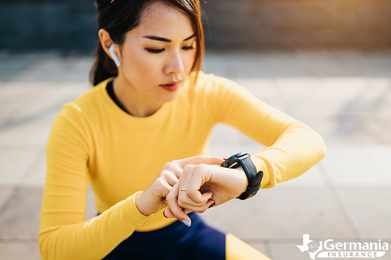 A woman using her fitness tracker during a workout 