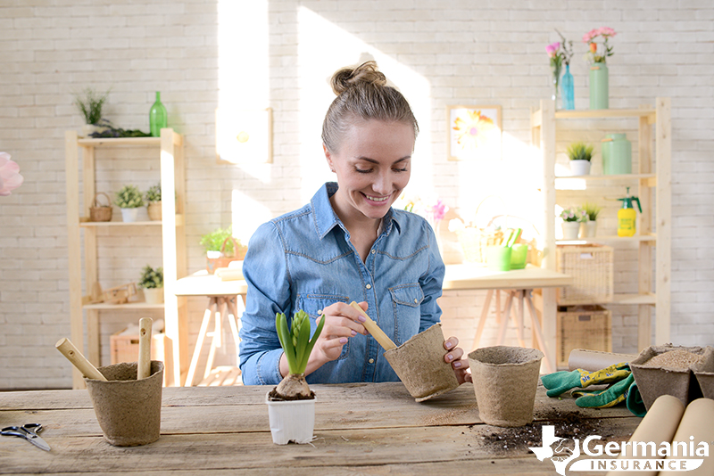 Woman decorating her rental home with plants.