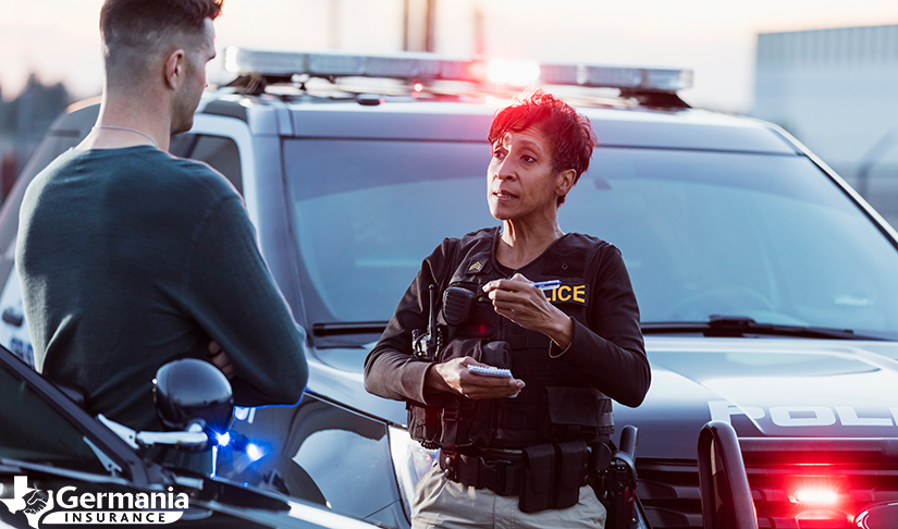 A police officer helping someone file a police report after an accident