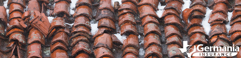 A clay tile roof damaged by hail.