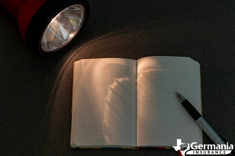 Flashlight and notepad used during a power outage