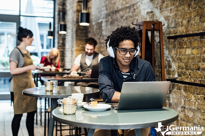 A man in a coffee shop staying safe on public Wi-Fi