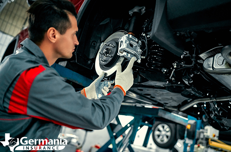 A man installing new brake pads and rotors on a car