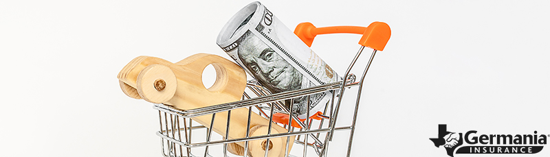 A toy truck in a basket with cash, representing auto insurance discount savings.