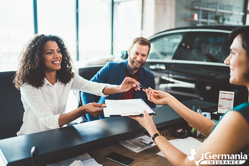 A woman receiving keys to a rental car