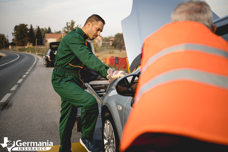 Tow truck driver providing roadside assistance coverage