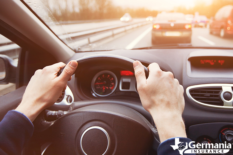 Hands on a steering practicing defensive driving