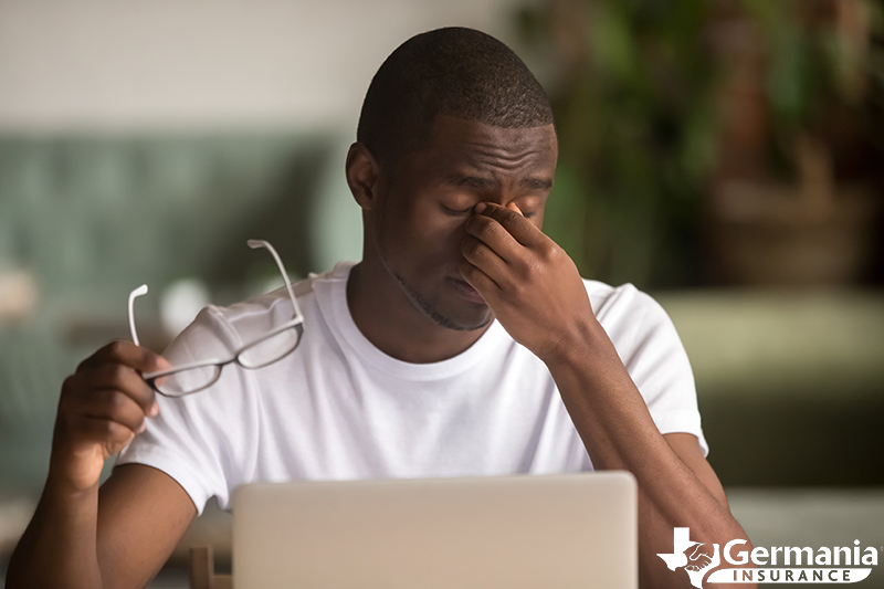 A man suffering from computer vision syndrome symptoms