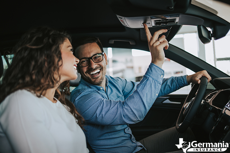 A couple test driving a used car before buying it