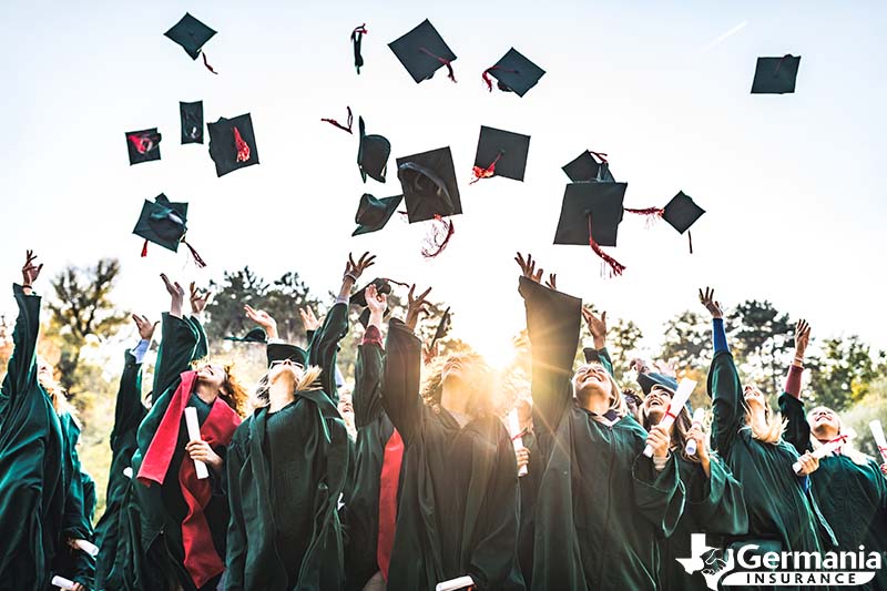 A graduating class of college students throwing their caps