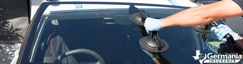 An auto glass technician replacing a cracked windshield